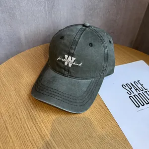 Detailed embroidery of letter W and for all mankind on washed cotton baseball cap