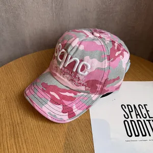 Detailed close-up of 3D embroidery on pink camouflage baseball cap with twill fabric texture
