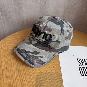 Detailed close-up of SANC embroidery on the camouflage cotton twill baseball cap