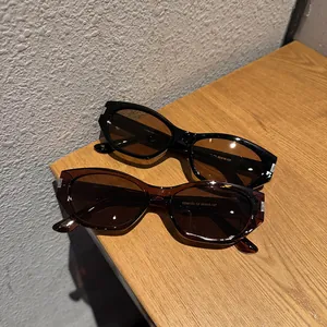 Retro cat-eye sunglasses set in black and tortoise shell with metal temple accents