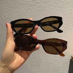 Vintage cat eye sunglasses in black and brown frames with metallic accents