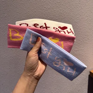 Set of three elastic knitted headbands in cream, pink and blue with Best Girl embroidery