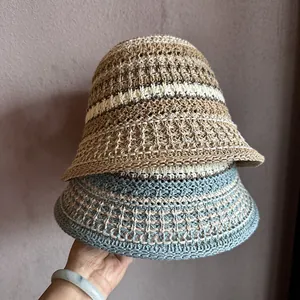 Close-up of handmade crochet bucket hats showing detailed stripes and woven texture