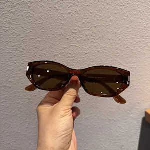 Close-up of KD98123 model code on amber resin temple of retro cat-eye sunglasses