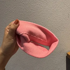 Detail of pink ribbed knit headband featuring elastic fabric and high-quality stitching