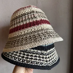 Detail of hand-woven crochet bucket hats with striped patterns and textured cotton yarn