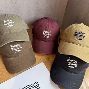 Flat lay of vintage washed cotton baseball caps with Sunday Running Club embroidery