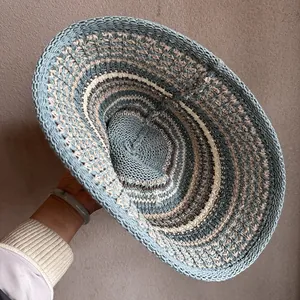 Blue handwoven straw sun hat with wide brim and breathable pattern for summer