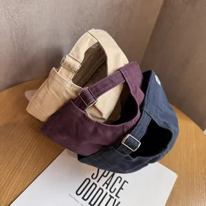 Drei Baumwoll-Baseballkappen in Beige, Burgunder und Navy auf Holz mit Metallschnalle