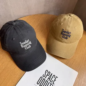 Detail of vintage cotton baseball caps in charcoal and khaki with Sunday Running Club embroidery
