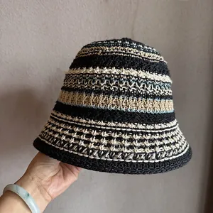 Close-up of hand-woven crochet texture on a striped straw bucket hat for women