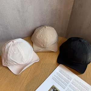 Three minimalist outdoor lightweight baseball caps in white, beige, and black colors