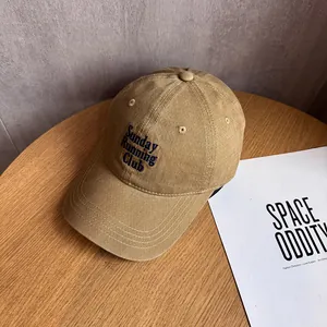 Detailed embroidery of Sunday RUNNING CLUB text on a khaki twill cotton baseball cap