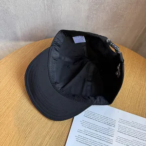 Detail view of cotton baseball cap interior with wash label and metal cross adjustment buckle