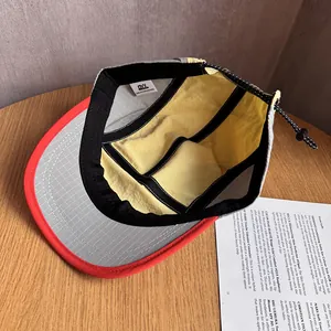 Detail view of quick-dry 5-panel hat interior with yellow lining and sweatband