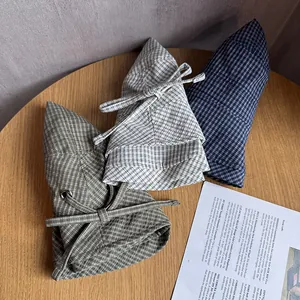 Three plaid wide brim bucket hats with bows in navy, olive green and beige colors