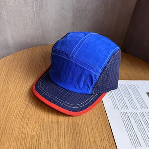 Detail shot of a color-block outdoor camp hat with lightweight fast-dry fabric texture