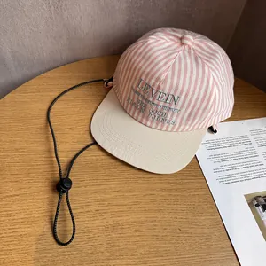 Detail of pink striped baseball cap with embroidery and adjustable windproof cord