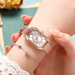 Close-up of rose gold square watch with mesh strap and matching crystal bracelet