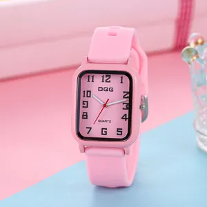 Detail of pink rectangular quartz watch with Arabic numerals and soft silicone strap