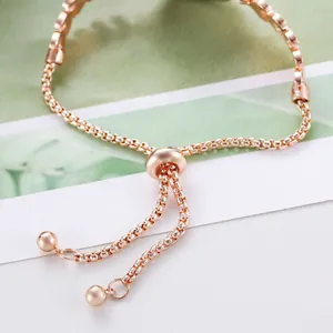Detail of rose gold box chain bracelet featuring a round sliding adjustable stopper