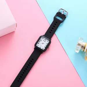 Detail of square quartz watch with black silicone strap and clear numeric dial