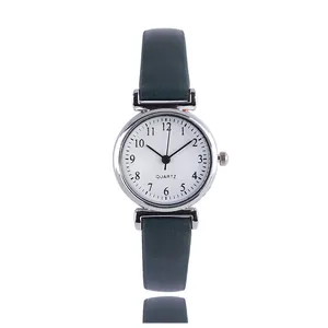 Minimalist women's quartz watch with dark green leather strap and silver round dial face