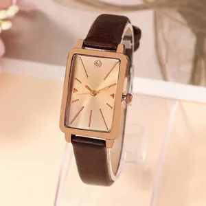 Women's vintage rectangular rose gold watch with brown leather strap and minimalist dial