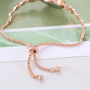 Macro detail of rose gold box chain bracelet watch with adjustable slider clasp