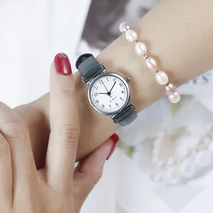 Close-up of vintage lady quartz watch with dark green leather strap and Arabic numerals
