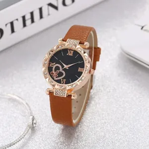 Elegant women's watch with heart dial, brown leather strap, and rose gold crystal bezel