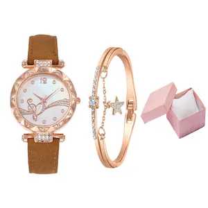 Detail of rose gold watch set with rhinestone bezel, star bracelet and pink jewelry box