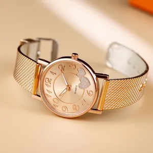 Detailed close-up of rose gold quartz watch featuring dual heart motifs on the dial