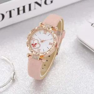Close-up of pink quartz watch with rose gold wavy bezel and rhinestone heart pattern