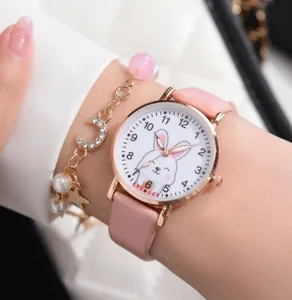 Detailed close-up of a pink cartoon rabbit quartz watch and matching charm bracelet set