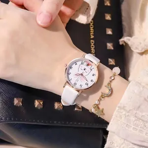 Detail of cartoon rabbit watch with matching gold star and moon charm bracelet