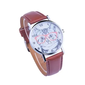 Detail of cute cat watch dial with pink glasses and brown leather strap on white backdrop