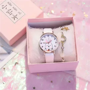 Close-up of white rabbit cartoon watch and gold star bracelet in a pink gift box