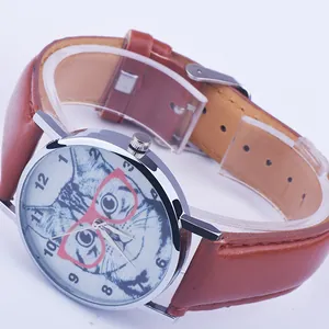 Detail of quartz watch featuring a brown leather strap and cute cat face on the dial