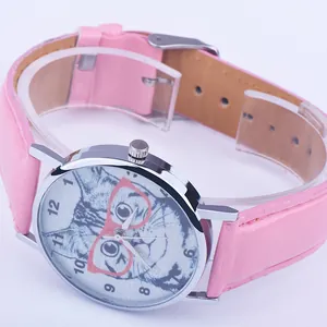 Detail view of the pink faux leather strap and silver watch case with cat face dial