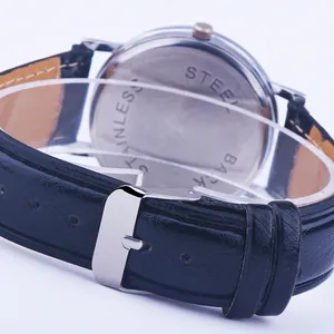 Detailed close-up of stainless steel watch back case and black faux leather strap buckle