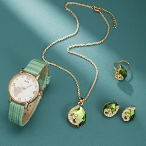 5-piece gold jewelry set with green teardrop stones, including watch, necklace and rings