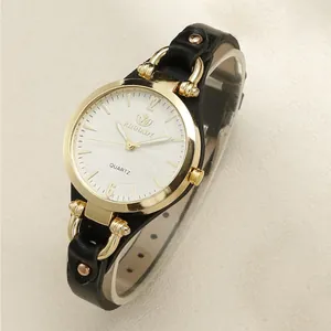 Detailed macro view of gold quartz watch with white spiral dial and black leather strap