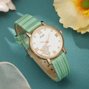 Detail of IFKF women's watch featuring a green checkered strap and butterfly dial pattern