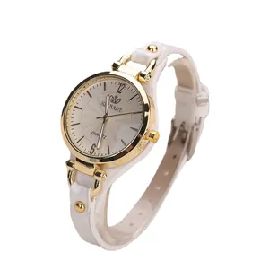 Women's quartz watch with gold round case, white leather strap and textured dial