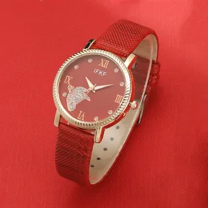 Detail of red leather watch strap with butterfly dial and Roman numerals markers