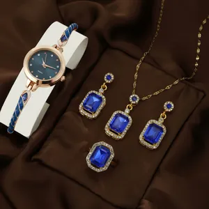 Elegant rose gold quartz watch and blue sapphire jewelry set for women on satin