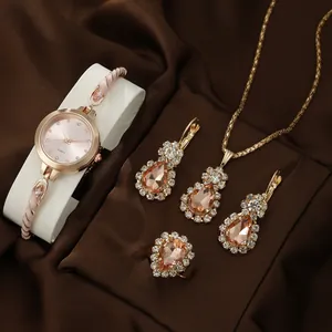 Elegant women's rose gold quartz watch and matching jewelry set on silk backdrop