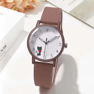 Detail of quartz watch featuring a brown silicone strap and a cute black cat on the dial