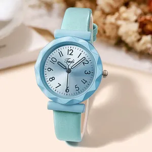 Detail of light blue leather watch featuring a faceted bezel and sunburst dial texture